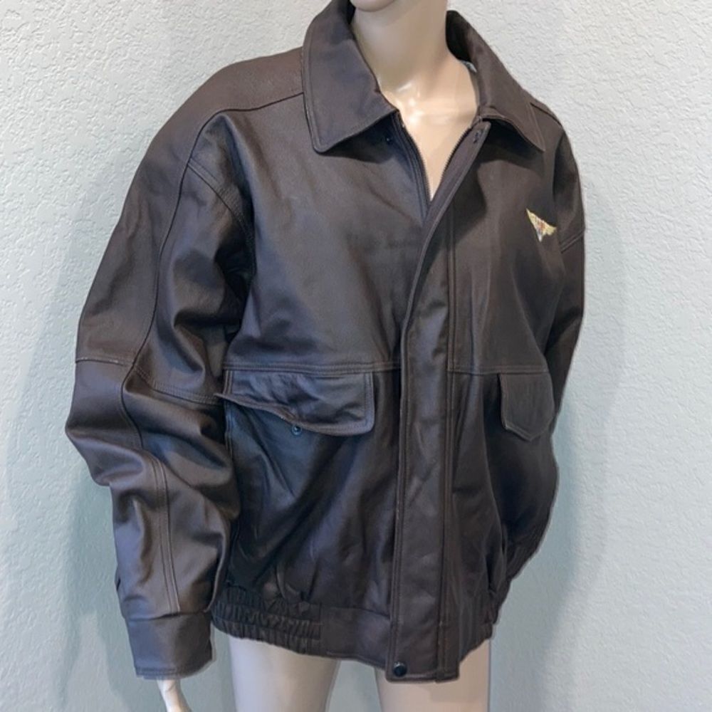 Burks Bay leather brown coat has a patch on the left side.